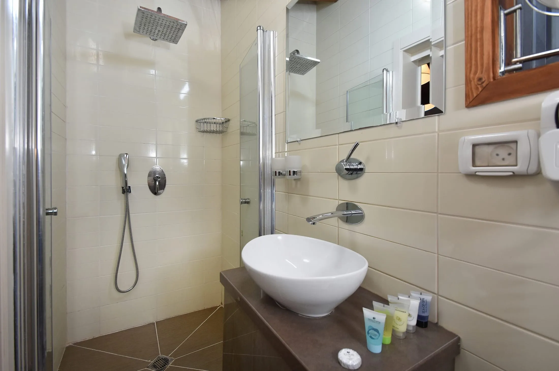 Modern suite bathroom with rainfall shower and vessel sink at Halomot Naftali resort